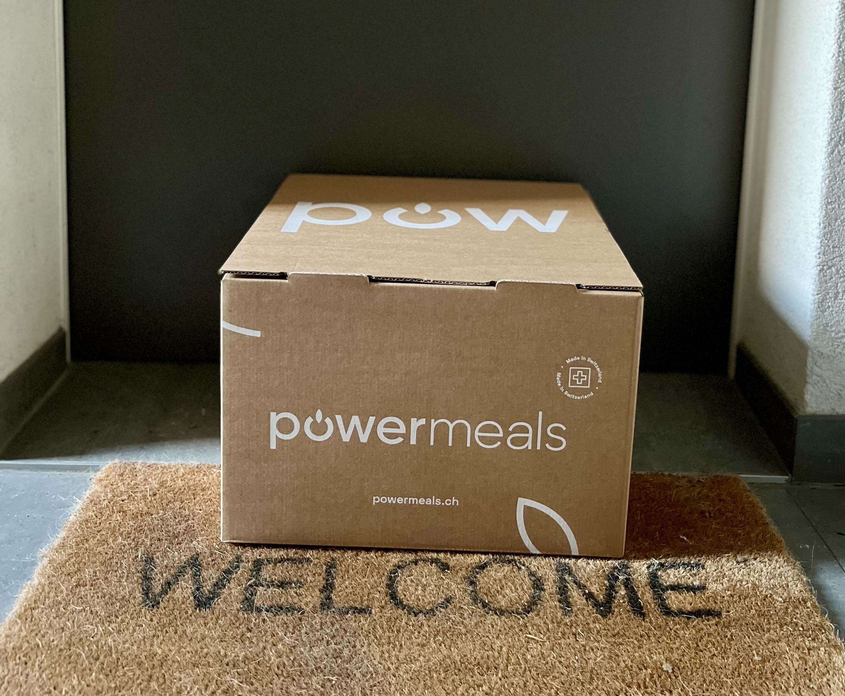 A Powermeals box on a welcome mat