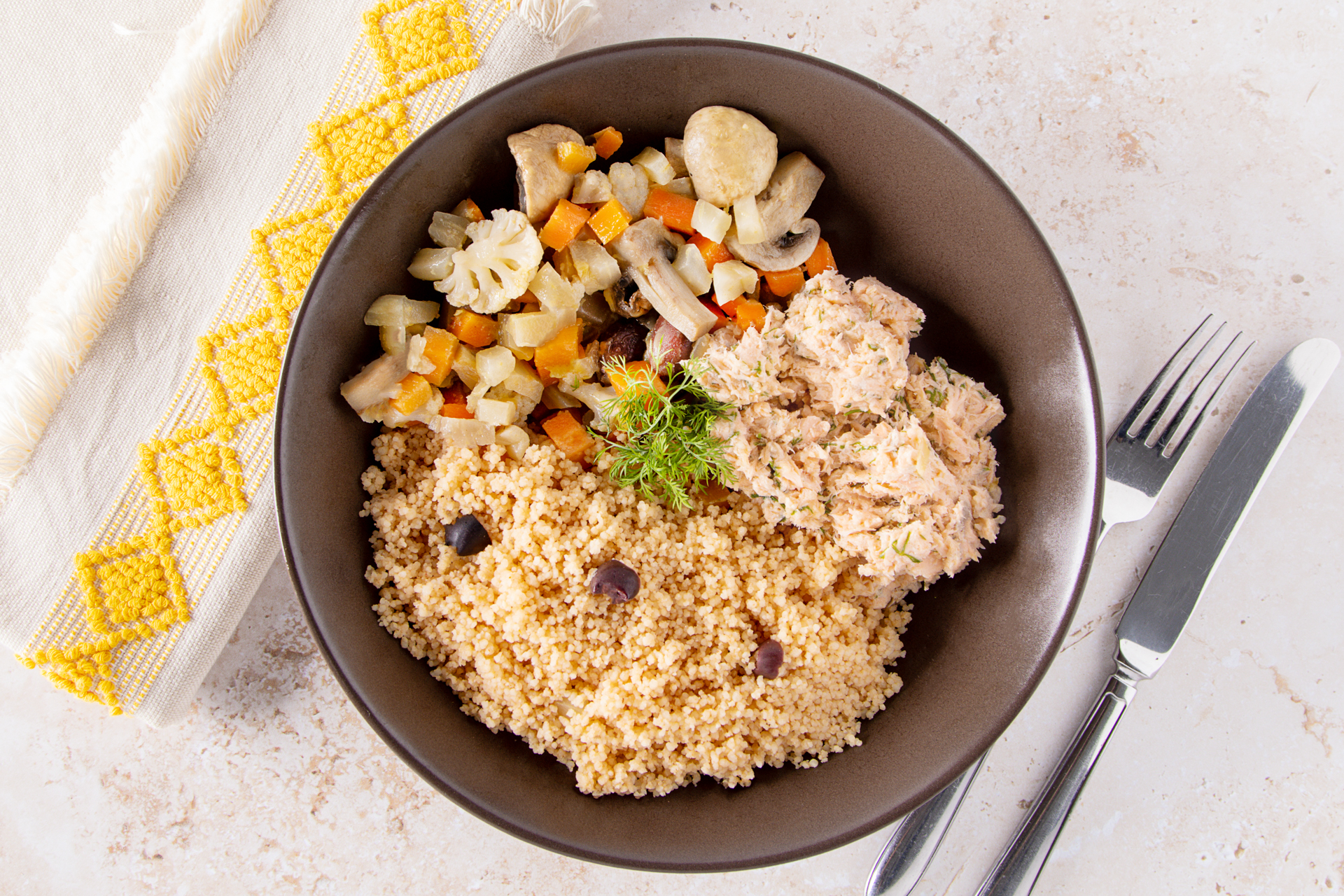 A plate of salmon rillette, couscous and Greek-style vegetables